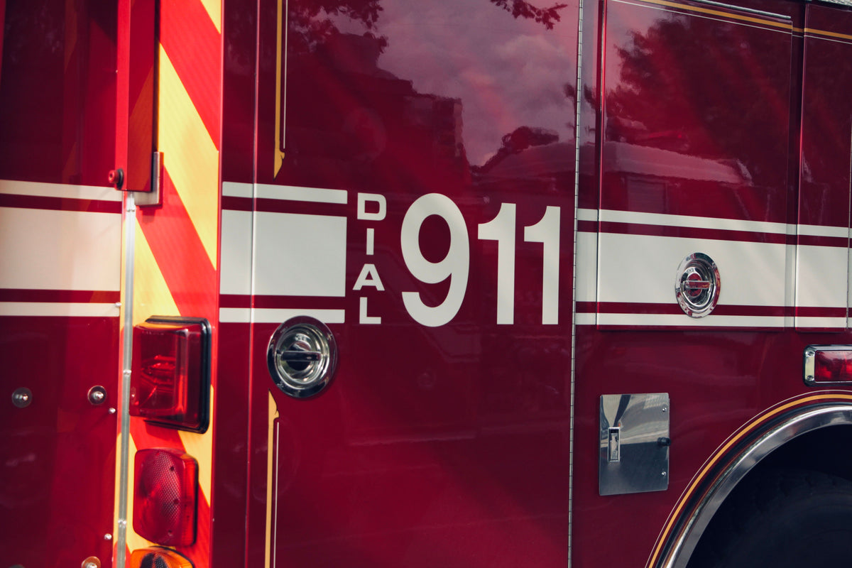 Image of red Firetruck with white letters DIAL 911 . Image by Ash H@pexels.com