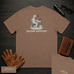 Teacher Assistant embroidered t-shirt in Espresso, Reading beside desk (Female)