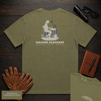 Teacher Assistant embroidered t-shirt in Hemp, Reading beside desk (Female)