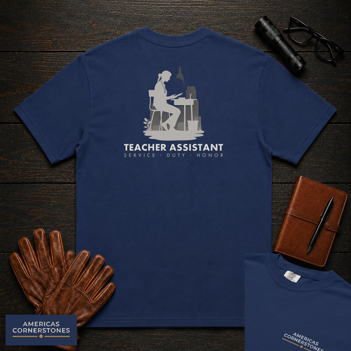 Teacher Assistant embroidered t-shirt in True Navy, Reading beside desk (Female)